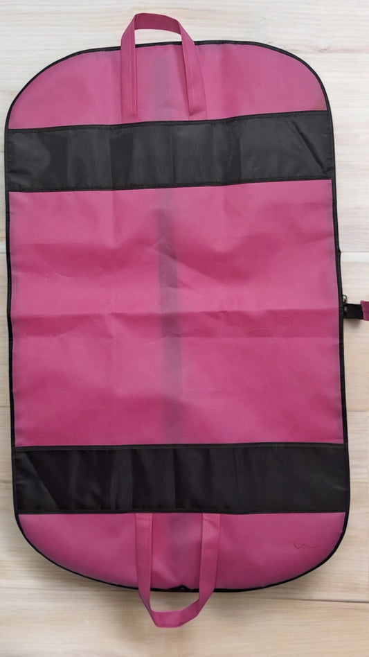Foldable pink non-woven suit cover with zipper, converts into a compact carry bag for travel and storage